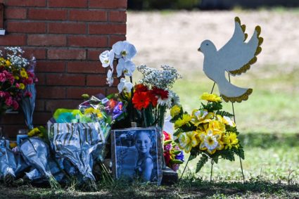 The photo of Makenna Lee Elrod, a little girl victim of the shooting, is seen by flowers placed on a makeshift memorial in front of Robb Elementary School in Uvalde, Texas, on May 25, 2022. Photo by CHANDAN KHANNA/AFP via Getty Images
