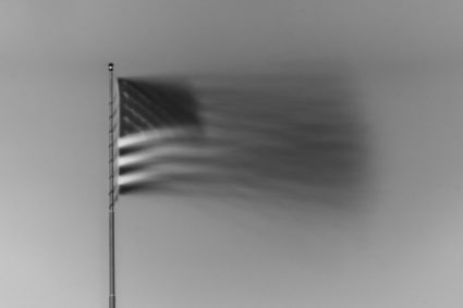 American flag waving in motion in black and white