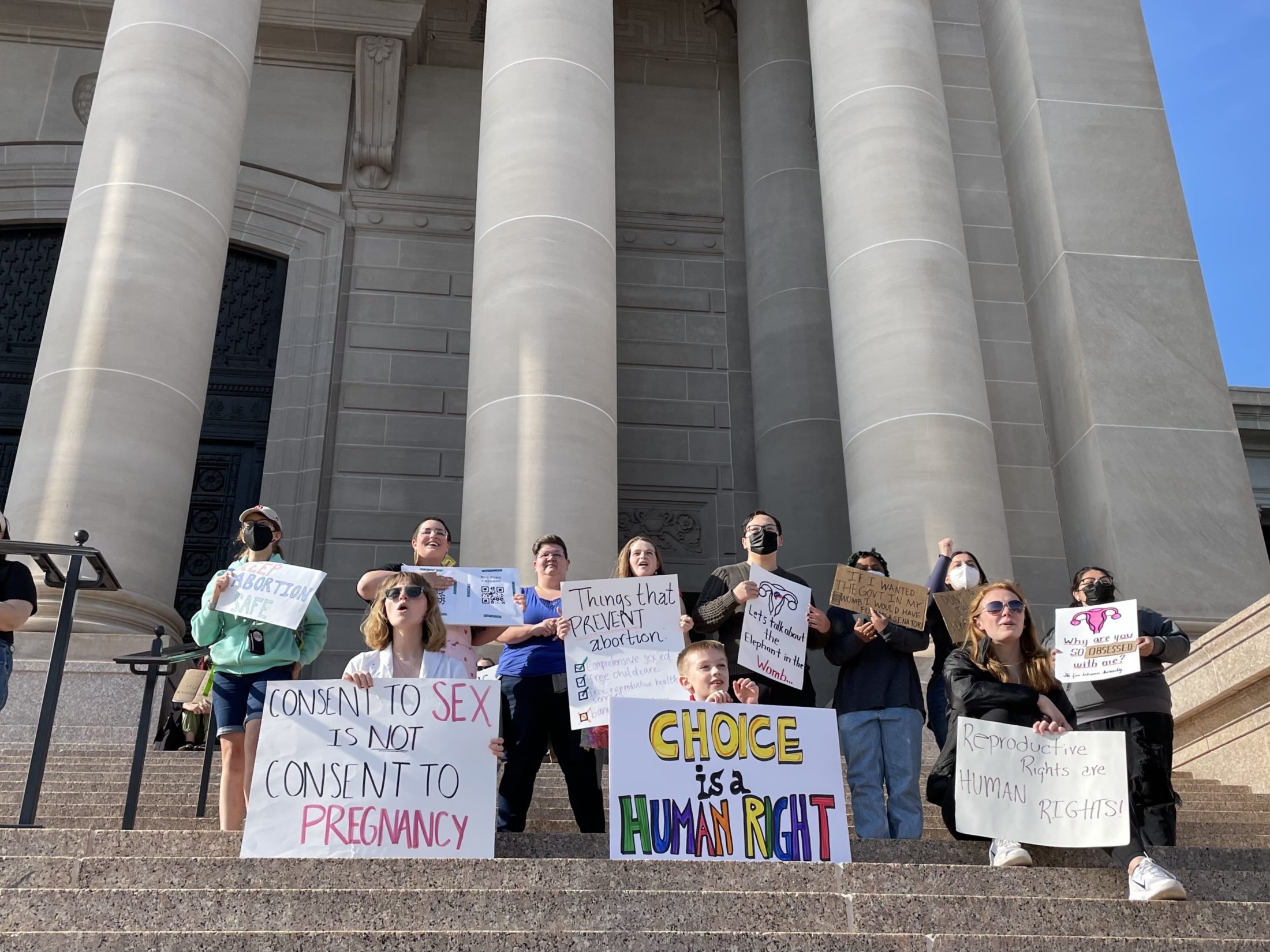 Abortion advocates hold up signs outside the Oklahoma State Capitol