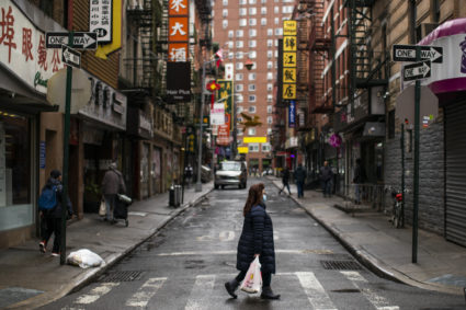 A woman wears a face mask as she walks in the Chinatown area during the outbreak of coronavirus disease (COVID-19), in New...