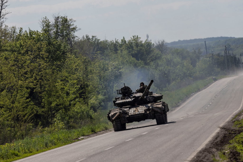 A Ukrainian tank drives along a road near in Bakhmut, in the Donetsk region, Ukraine
