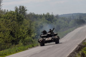 A Ukrainian tank drives along a road near in Bakhmut, in the Donetsk region, Ukraine