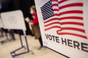 An American flag sign is seen on a voting booth at Madison Square Garden, which is used as a polling station on the first day of early voting in Manhattan, New York, U.S. October 24, 2020. Photo by Jeenah Moon/REUTERS
