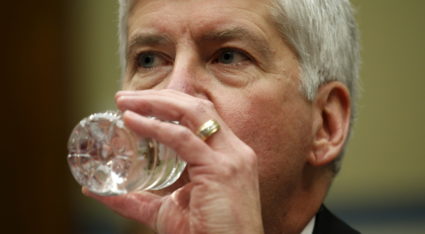 Michigan Governor Rick Snyder drinks some water as he testifies for Flint Michigan water hearing on Capitol in Washington
