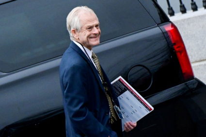 FILE PHOTO: Former White House advisor Peter Navarro leaves the West Wing carrying a poster board displaying claims of vot...