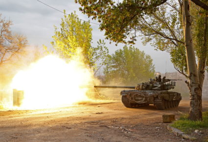 Service members of pro-Russian troops fire from a tank in Mariupol