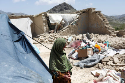 An Afghan girl stands near her house that was damaged by an earthquake in Kalizei village in the Gayan district of Paktika province, Afghanistan, June 26, 2022. Photo by Ali Khara/REUTERS