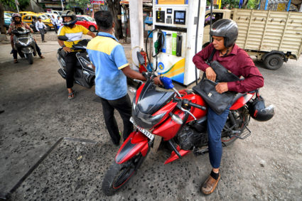 People seen refilling their Motorcycles at a Petrol pump.