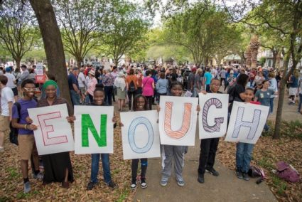 Kids hold "Enough" sign at March For Our Lives event