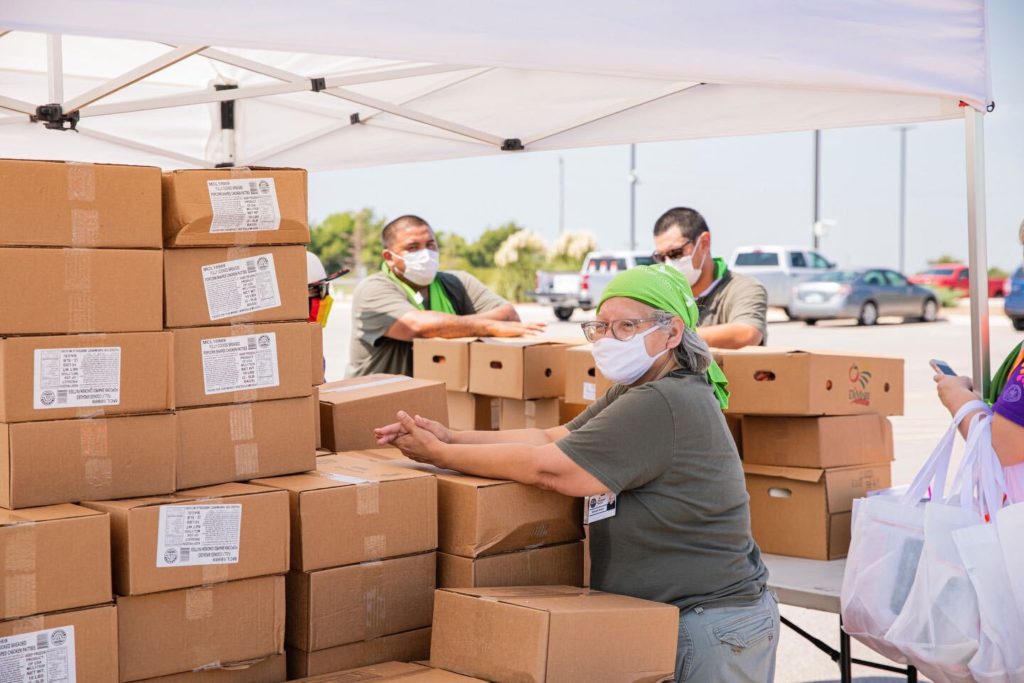Staff for the Chickasaw Nation Medical Center in Oklahoma prepares meal kits for a drive thru event to feed community memb...