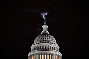 The moon is seen behind the dome of the U.S. Capitol building at night in Washington, DC, U.S., February 16, 2022. Photo by Jon Cherry/REUTERS