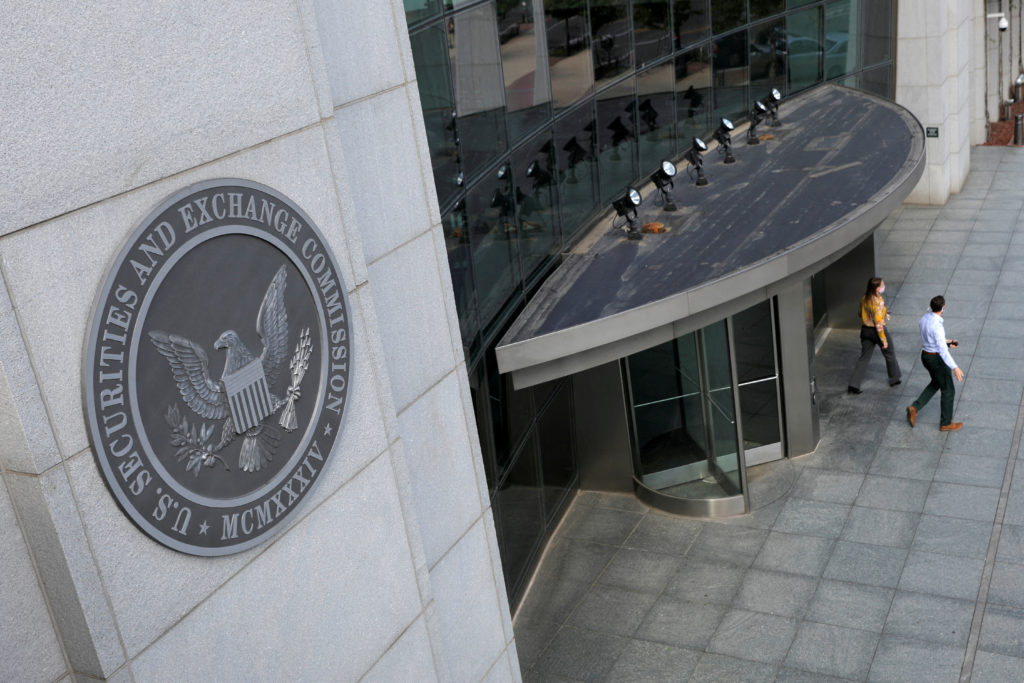 FILE PHOTO: People exit the headquarters of the U.S. Securities and Exchange Commission in Washington, D.C.