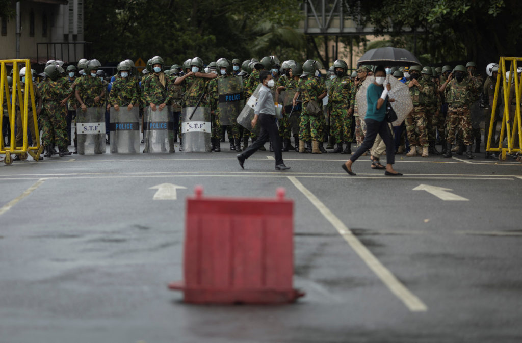 Security personnel stand guard during a protest near the Presidential Secretariat in Colombo
