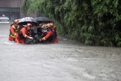 Rescue workers evacuate residents from a flooded road amid heavy rainfall in Hefei