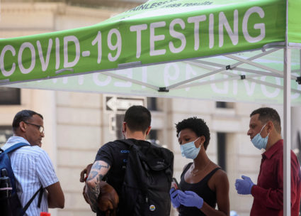 FILE PHOTO: People wait to take coronavirus disease (COVID-19) tests at a pop-up testing site in New York