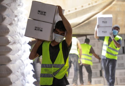 Workers carry boxes of humanitarian aid near Bab al-Hawa crossing at the Syrian-Turkish border, in Idlib governorate, Syria, June 30, 2021. Picture taken June 30, 2021. Photo by Mahmoud Hassano/REUTERS