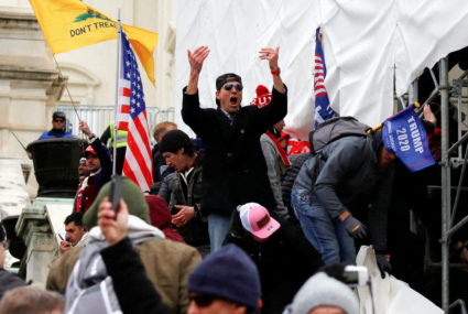 A man, identified as Ryan Kelley in a sworn statement by an FBI agent, gestures as supporters of U.S. President Donald Tru...