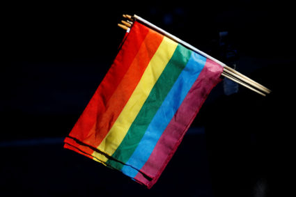 A man sells rainbow flags near The Stonewall Inn, on the eve of the LGBT Pride March, in the Greenwich Village section of ...