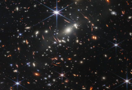 The first image from NASA’s James Webb Space Telescope is the deepest and sharpest infrared image of the distant universe to date. Known as Webb’s First Deep Field, this image of galaxy cluster SMACS 0723 is overflowing with detail. Thousands of galaxies – including the faintest objects ever observed in the infrared – have appeared in Webb’s view for the first time. This slice of the vast universe covers a patch of sky approximately the size of a grain of sand held at arm’s length by someone on the ground. Image courtesy of NASA, ESA, CSA, and STScI