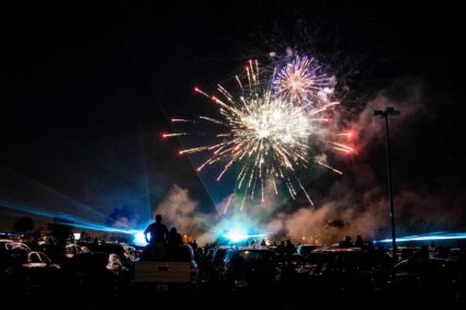 Attendees watch from their cars during an Independence Day drive-in firework and laser light show at the Naples-Fort Myers