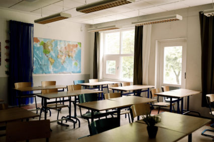 Desks and chairs arranged in classroom at high school