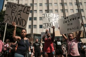 Demonstrators hold "Justice for Jayland" signs as they gather outside Akron City Hall to protest the killing of Jayland Walker, shot by police, in Akron, Ohio, July 3, 2022. Photo by Matthew Hatcher / AFP via Getty Images