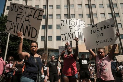 Demonstrators hold "Justice for Jayland" signs as they gather outside Akron City Hall to protest the killing of Jayland Walker, shot by police, in Akron, Ohio, July 3, 2022. Photo by Matthew Hatcher / AFP via Getty Images