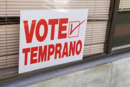 A sign written in Spanish and pointing to an early voting station is seen in Dodge City
