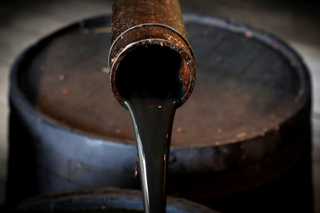 FILE PHOTO: Oil pours out of a spout from Edwin Drake's original 1859 well that launched the modern petroleum industry at ...