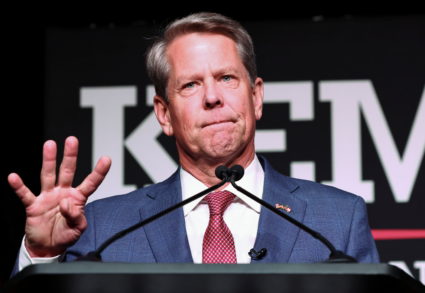 Governor Brian Kemp holds up four fingers to indicate "four more years" as he speaks after winning the Republican primary during his primary election watch party in Atlanta, Georgia, U.S. May 24, 2022. Photo by Dustin Chambers/REUTERS