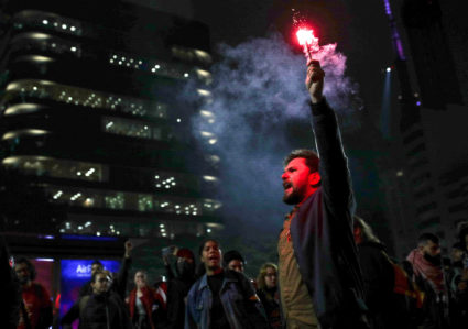 A demonstrator holds a flare during a protest for democracy and free elections and against Brazil's President Jair Bolsonaro, in Sao Paulo, Brazil, August 11, 2022. Photo by Amanda Perobelli/REUTERS