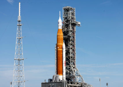 NASA's next-generation moon rocket, the Space Launch System (SLS), with the Orion crew capsule perched on top, stands on l...