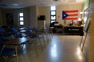 Ms. Martinez, a teacher at Iroquois High School, juggles between hers and her children's classes during a virtual learning...