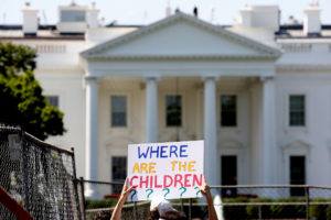 An immigration activists hold signs against family separation during a rally to protest against the Trump Administration's...