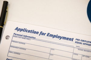 An employment application form is displayed during a restaurant job career fair in New York