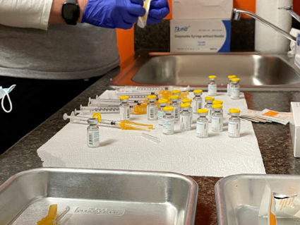 Health care professionals prepare monkeypox vaccines at the Test Positive Aware Network nonprofit clinic in Chicago, Illinois