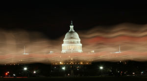 Illuminated balloons in long exposure image, color the sky in front of the U.S. Capitol during the Light The Night Walk in...