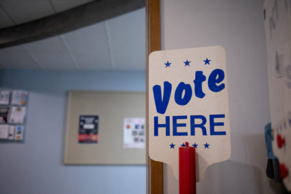 A 'Vote Here' sign is seen at a precinct the day before Michigan Democrats and Republicans choose their nominees to contest November's congressional elections, which will determine which party controls U.S. House of Representatives for next two years, in Birmingham, Michigan, U.S. August 1, 2022. Photo by Emily Elconin/REUTERS