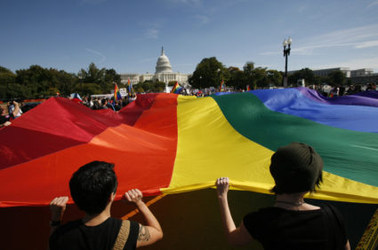 Participants carry a large rainbow flag towards the U.S. Capitol during a gay rights demonstration in Washington October 11, 2009. Photo by Molly Riley/REUTERS