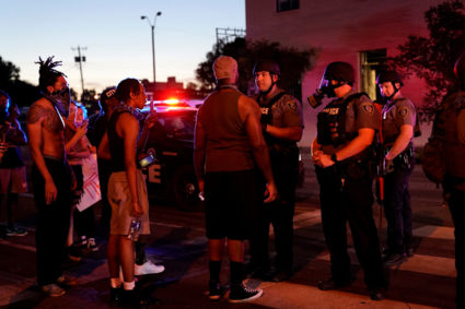 In this May 2020 photo, Oklahoma City Police officers speak with a crowd of protesters during nationwide demonstrations following the police killing of George Floyd in Minneapolis. Photo by Nick Oxford/Reuters