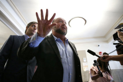FILE PHOTO: Alex Jones talks to media during a midday break during the start of a jury trial in Austin