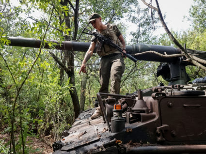 A Ukrainian service member stands at a German self-propelled gun Panzerhaubitze 2000 at the frontline in Donetsk region