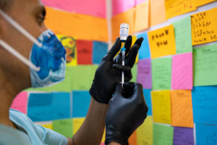 People receive COVID-19 boosters targeting Omicron