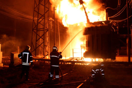 Firefighters work at a site of a thermal power plant damaged by a Russian missile strike in Kharkiv