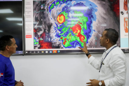Members of the Emergency Operations Committee (COE) monitor the trajectory of Hurricane Fiona in Santo Domingo