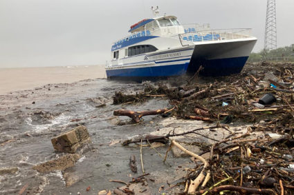 A boat lies washed up on shore after the passing of Hurricane Fiona in Ponce, Puerto Rico September 19, 2022. Photo by Ricardo Ortiz/REUTERS