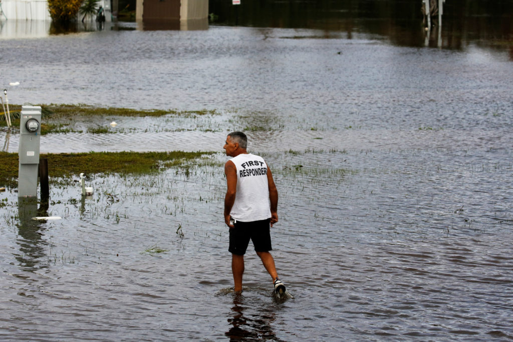 A man walks amid flooding after Hurricane Ian caused widespread destruction in Fort Myers, Florida, U.S., September 29, 2022. Photo by Marco Bello/REUTERS