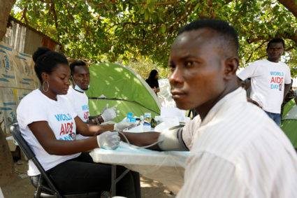 A health worker examines a man during an HIV/AIDS awareness campaign on the occasion of World AIDS Day at the Kuchingoro I...