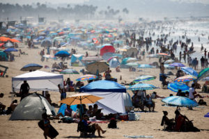 People crowd the beach on the record heat wave