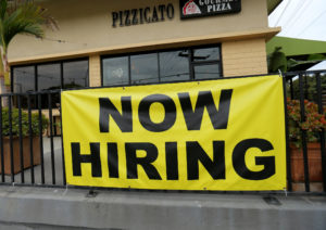 A local pizza restaurant advertises for workers in Encinitas, California